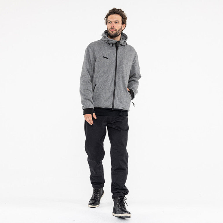 Man wearing a gray jacket and black pants on a white background